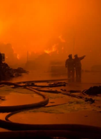 Photo of two firefighters in a wildfire.