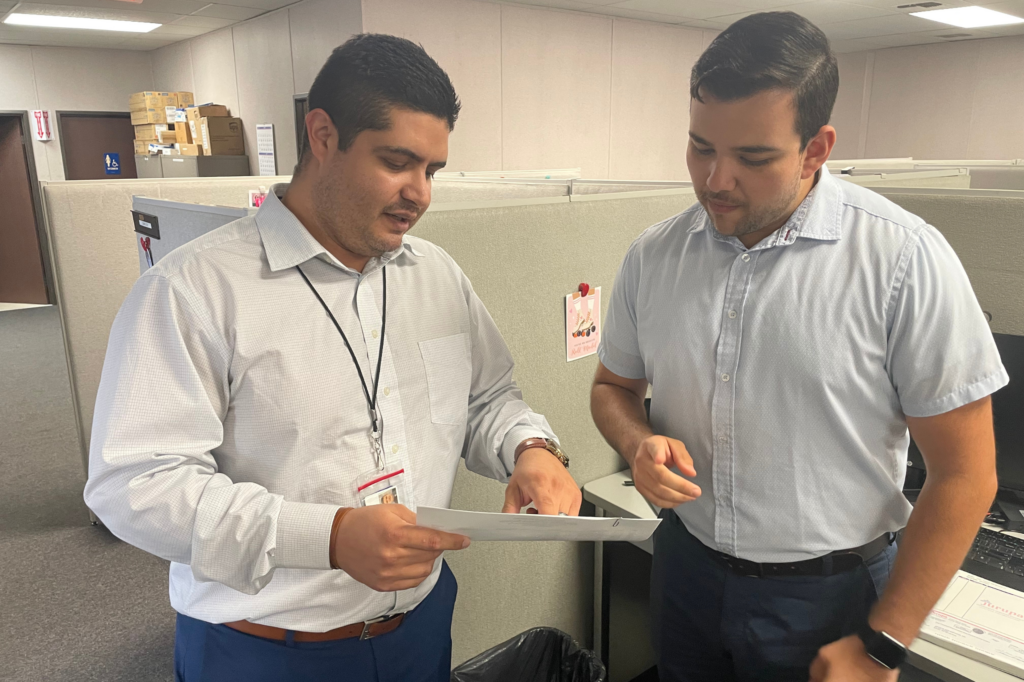 Employees looking at a paper